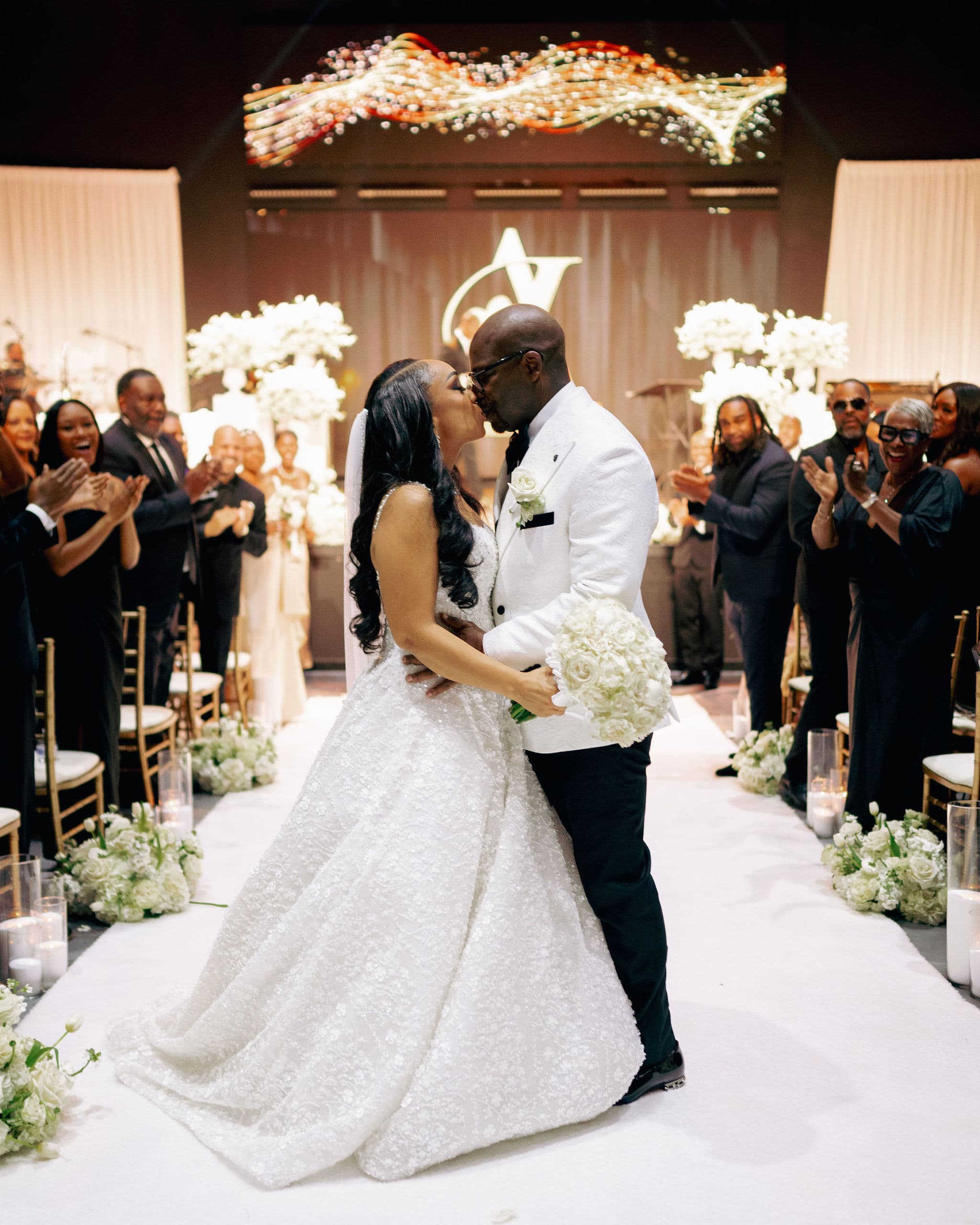 Laterras and Ashley Whitfield kissing at the altar on their wedding day